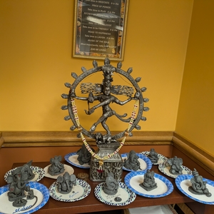 An idol of Shiva in the Yale Hindu prayer room, surrounded by clay sculptures of Ganesh