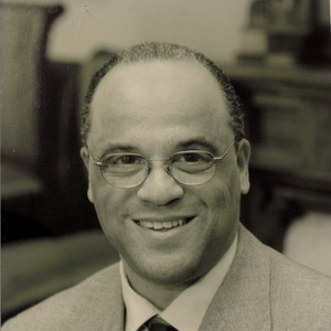 Black and white photo of Frederick Streets, a Black man with short cropped hair wearing a suit and glasses.