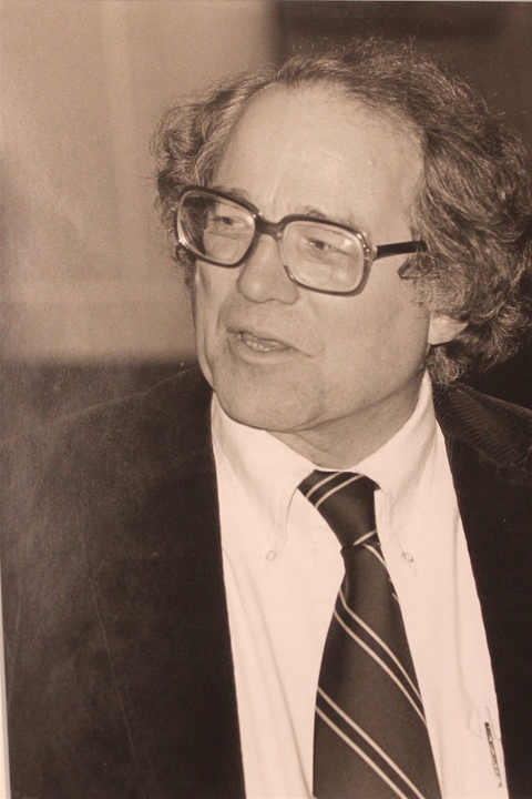 Black and white photo of William Sloane Coffin Jr., a white man with medium length slicked back hair and thick glasses