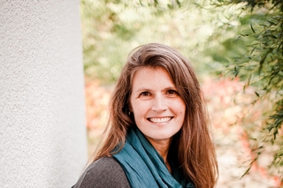 Jamie Nachtigall, a white woman with brown hair and blonde highlights, smiling at the camera.