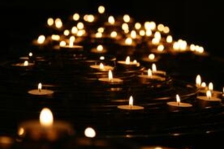 Lit candles floating along water