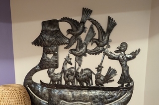 flat metal art of Noah's arc on the wall of the chaplain's office lounge