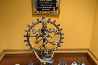 A small idol of Shiva dancing surrounded by clay ganeshas.